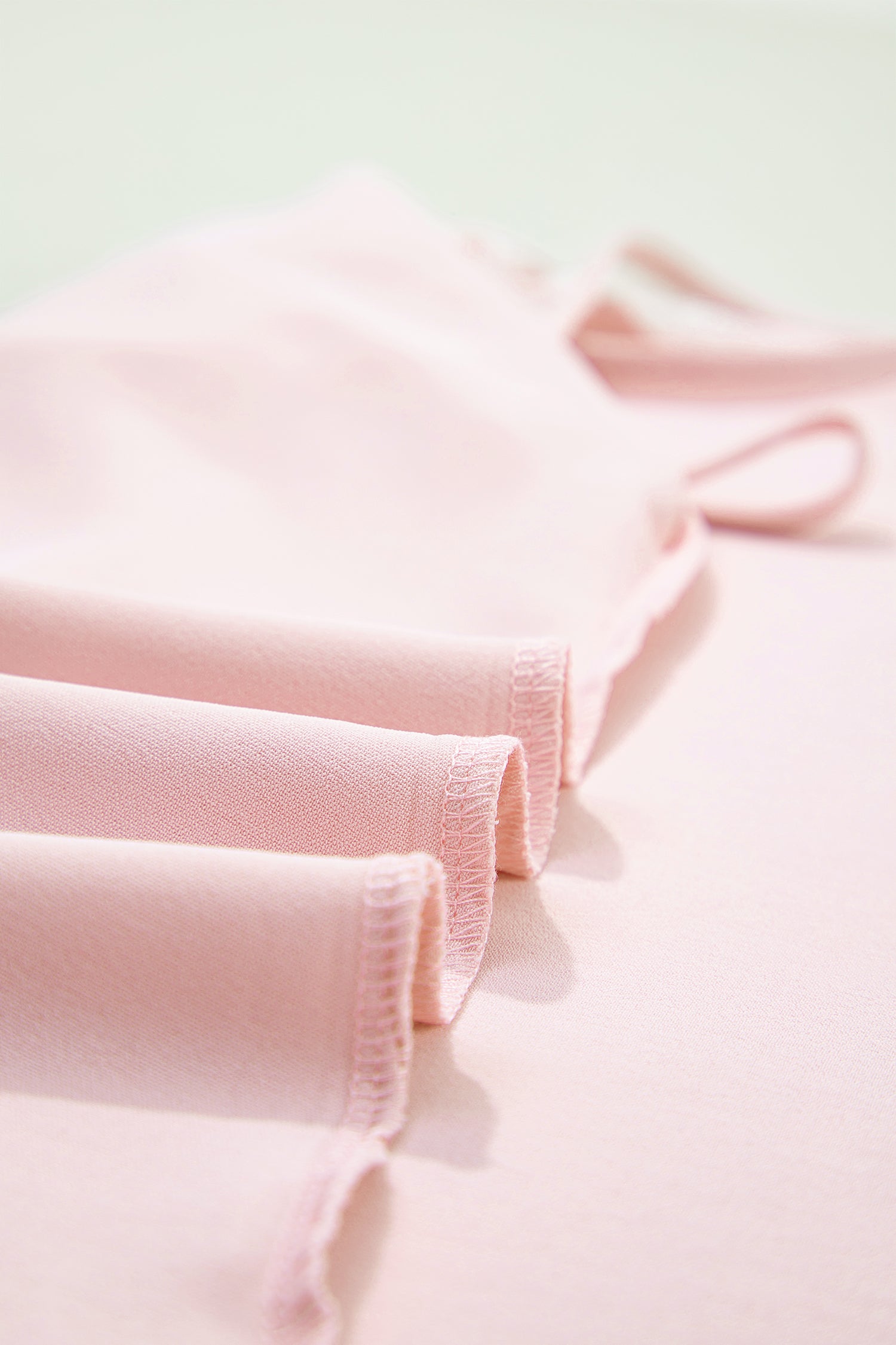 Close-up of pink fabric with a soft texture on a light background