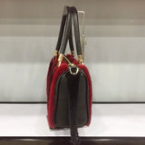 Black handbag with red fur trim on a white background