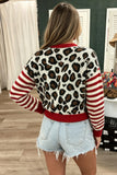 Back view of woman in leopard-print sweater with red-white striped sleeves and denim shorts.