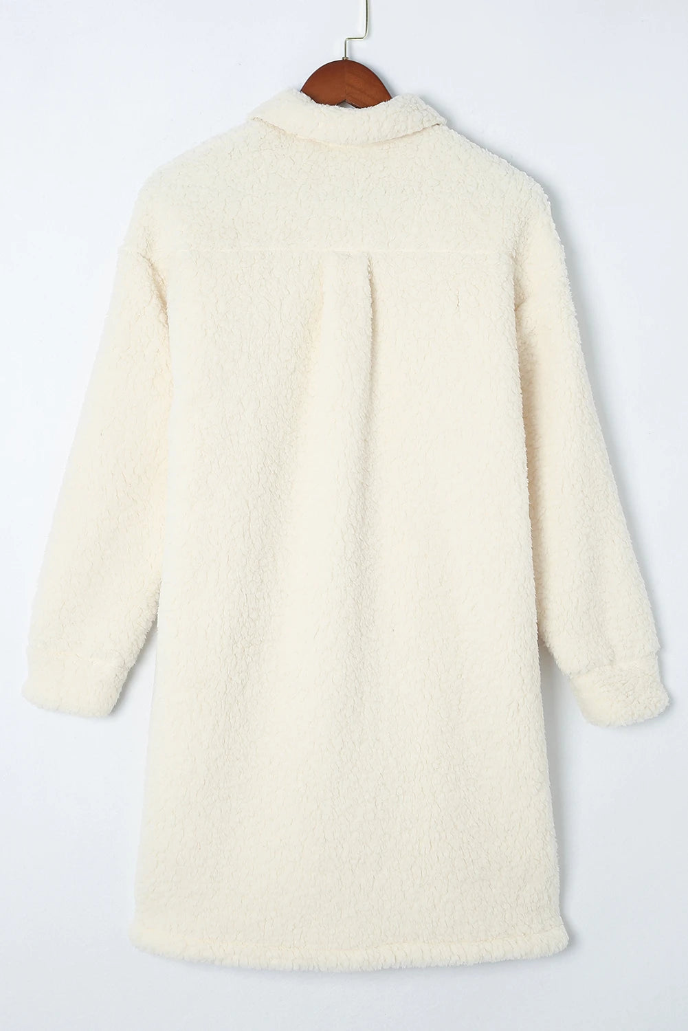 Off-white sherpa fleece shirt jacket with long sleeves on a wooden hanger.