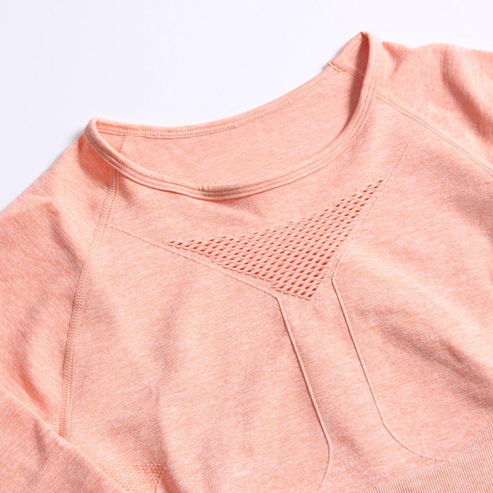 Close-up of a pink sweatshirt with textured design on a light gray background