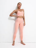 Woman wearing a pink athletic outfit against a white background