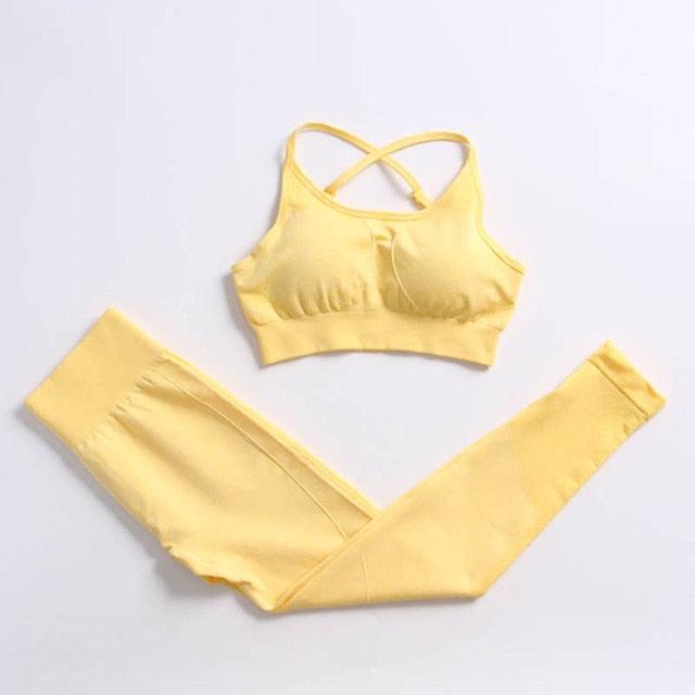Yellow sports bra and leggings set on a light gray background