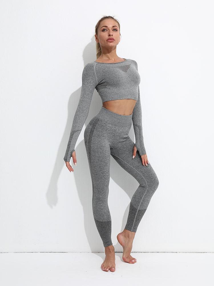 Woman wearing a gray athletic outfit on a white background