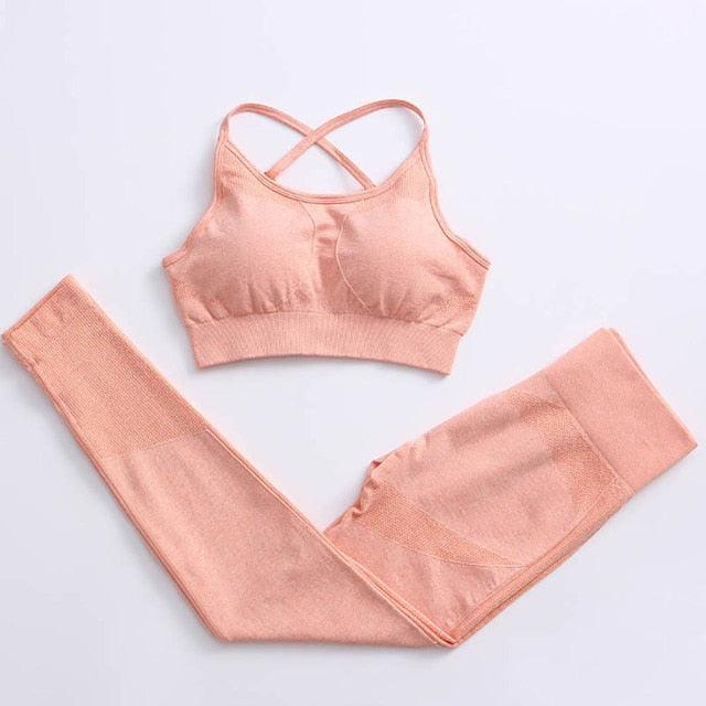 Pink sports bra and leggings set on a light gray background