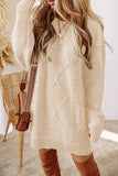 Woman wearing a beige cable knit sweater with brown knee-high boots, standing against a neutral background.
