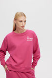 Person wearing a pink sweatshirt with text on a light gray background