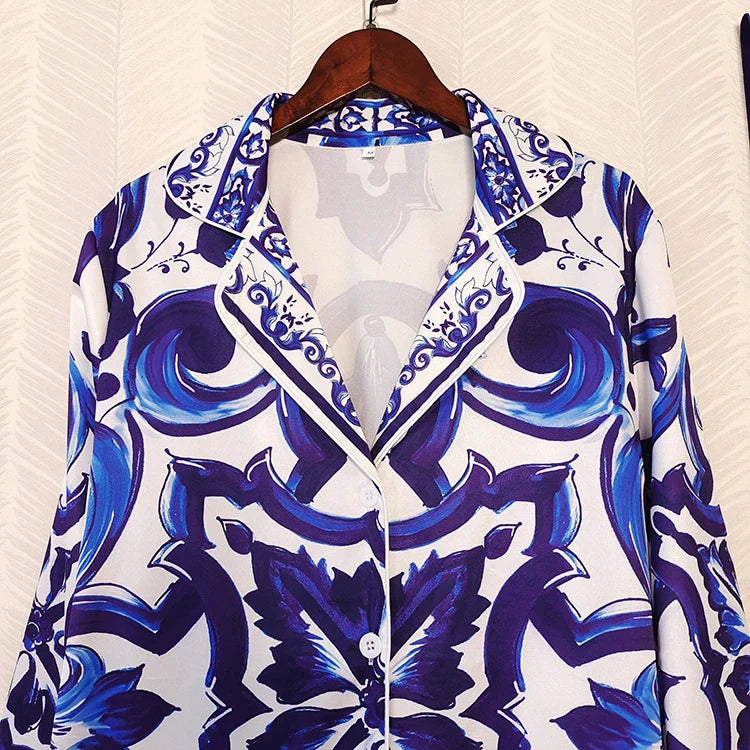 Blue and white patterned shirt on a hanger against a white background