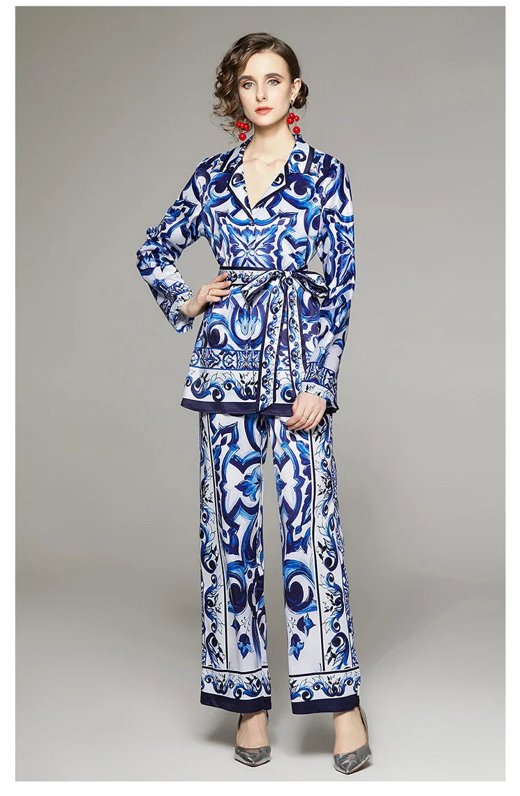 Woman wearing a blue and white patterned outfit on a gray background