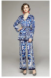 Woman wearing a blue and white patterned outfit on a gray background