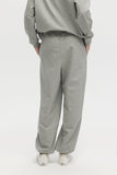 Person wearing gray sweatpants and a matching top on a white background