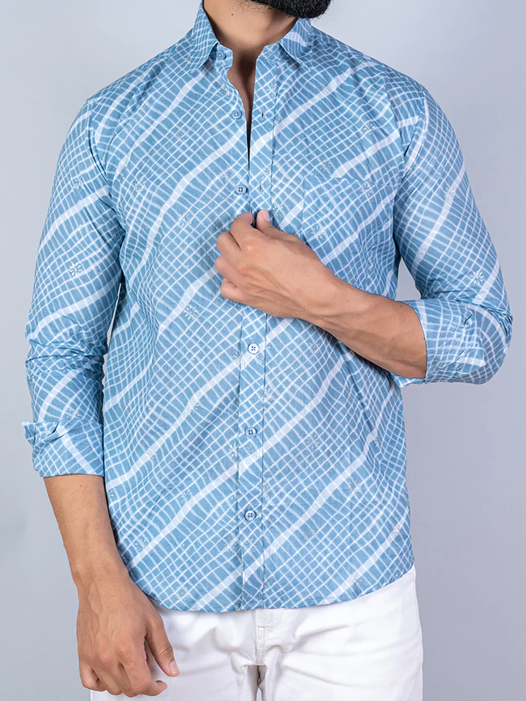 Person wearing a blue checkered shirt with white background