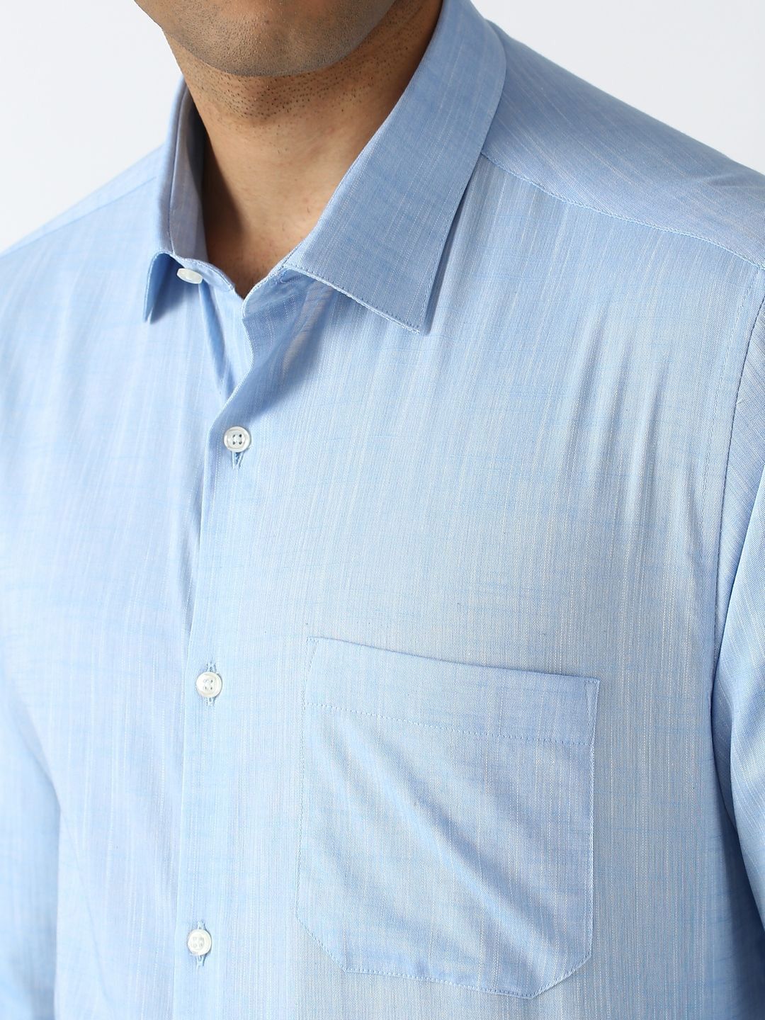Close-up of a light blue striped shirt with a collar and pocket.