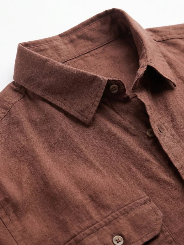 Close-up of a brown shirt with collar and buttons on a white background