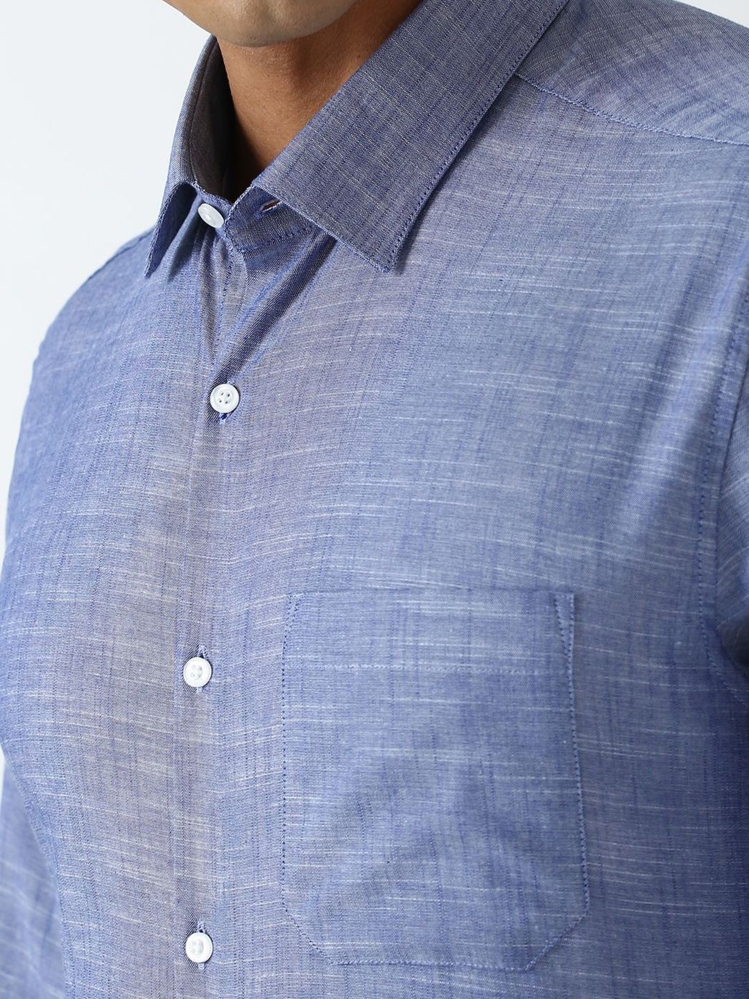 Close-up of a blue checkered shirt with buttons on a plain background