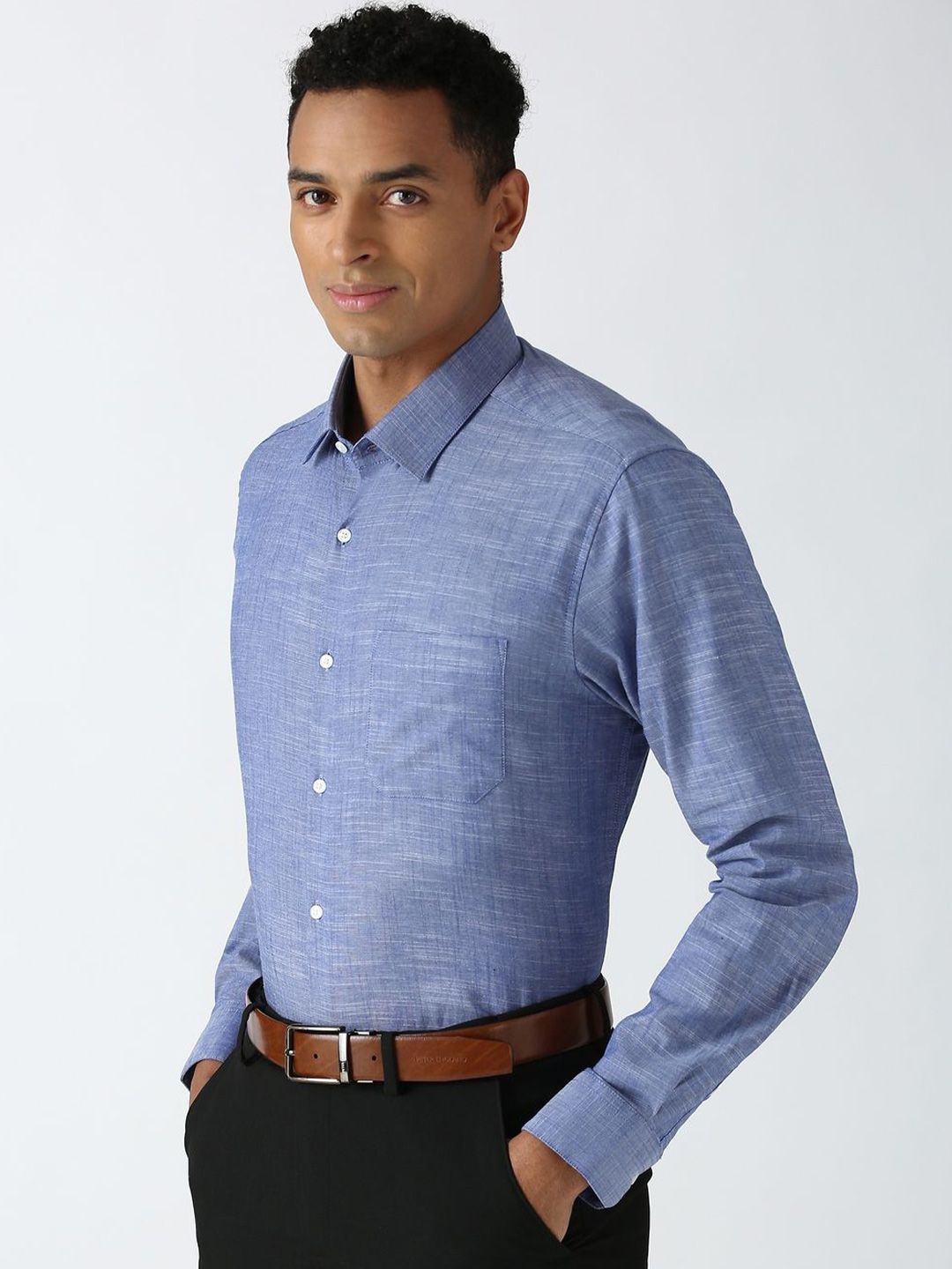 Man wearing a blue checkered shirt with a white background