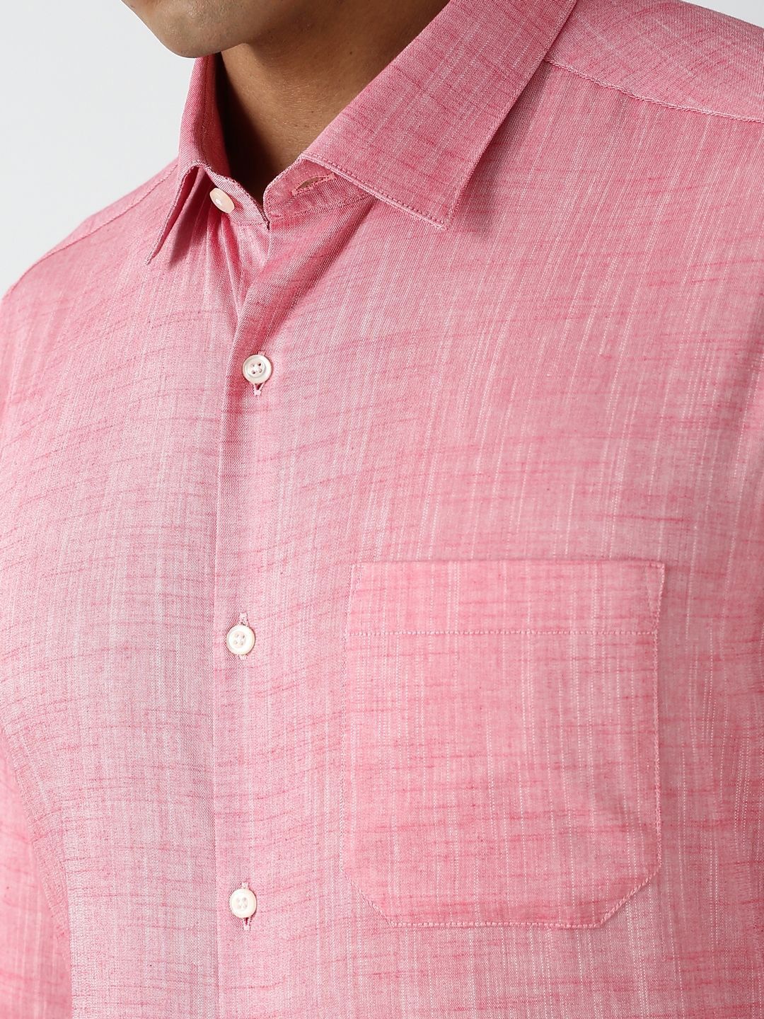 Close-up of a pink checkered shirt with a collar and buttons.