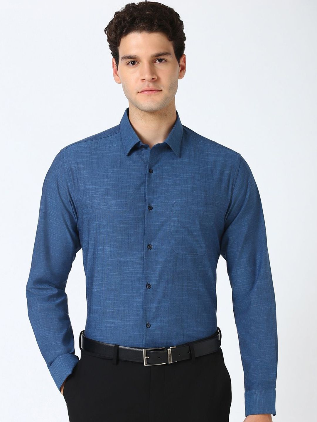 Man wearing a blue dress shirt with a white background