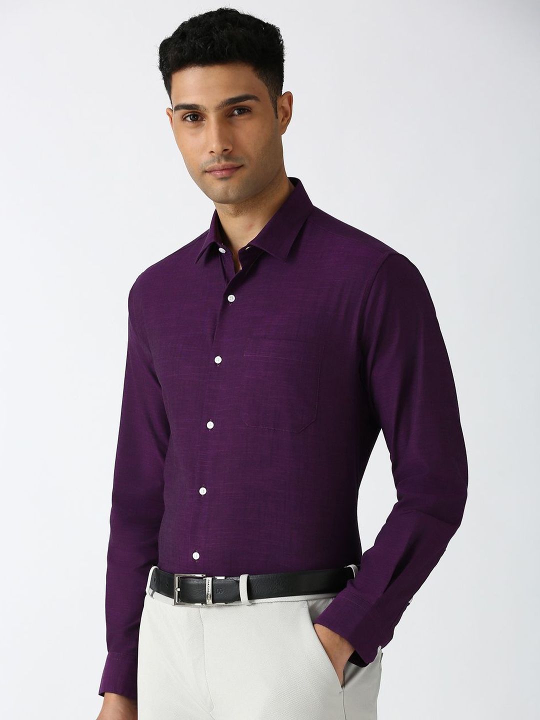 Man wearing a purple shirt with a white background