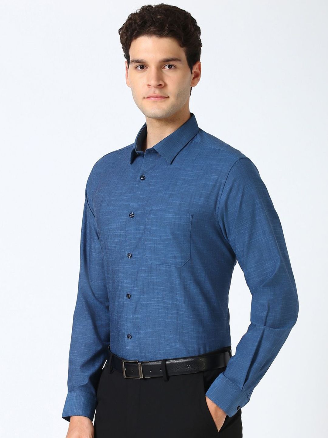 Man wearing a blue dress shirt on a white background
