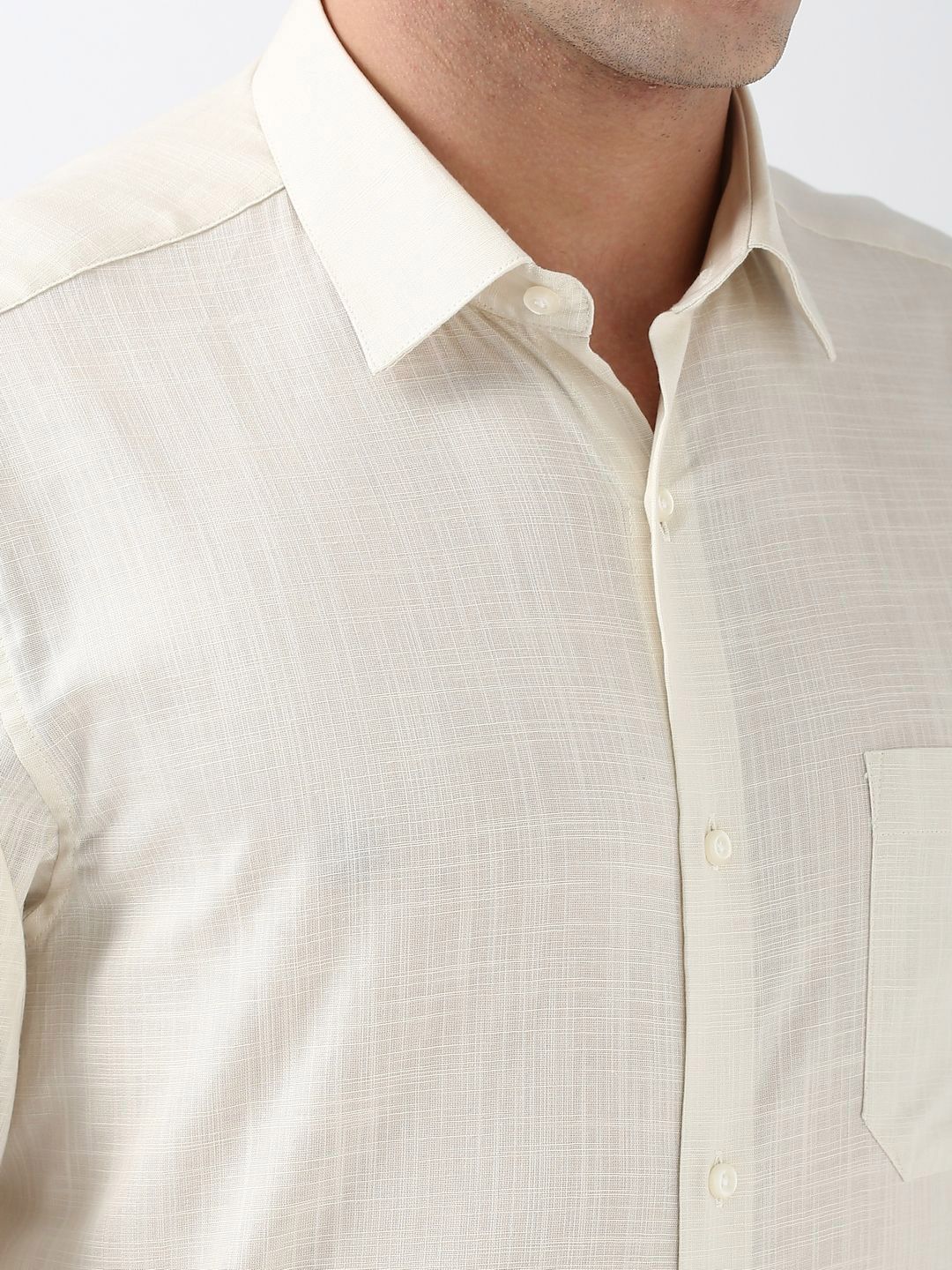 Close-up of a beige shirt with a collar on a white background