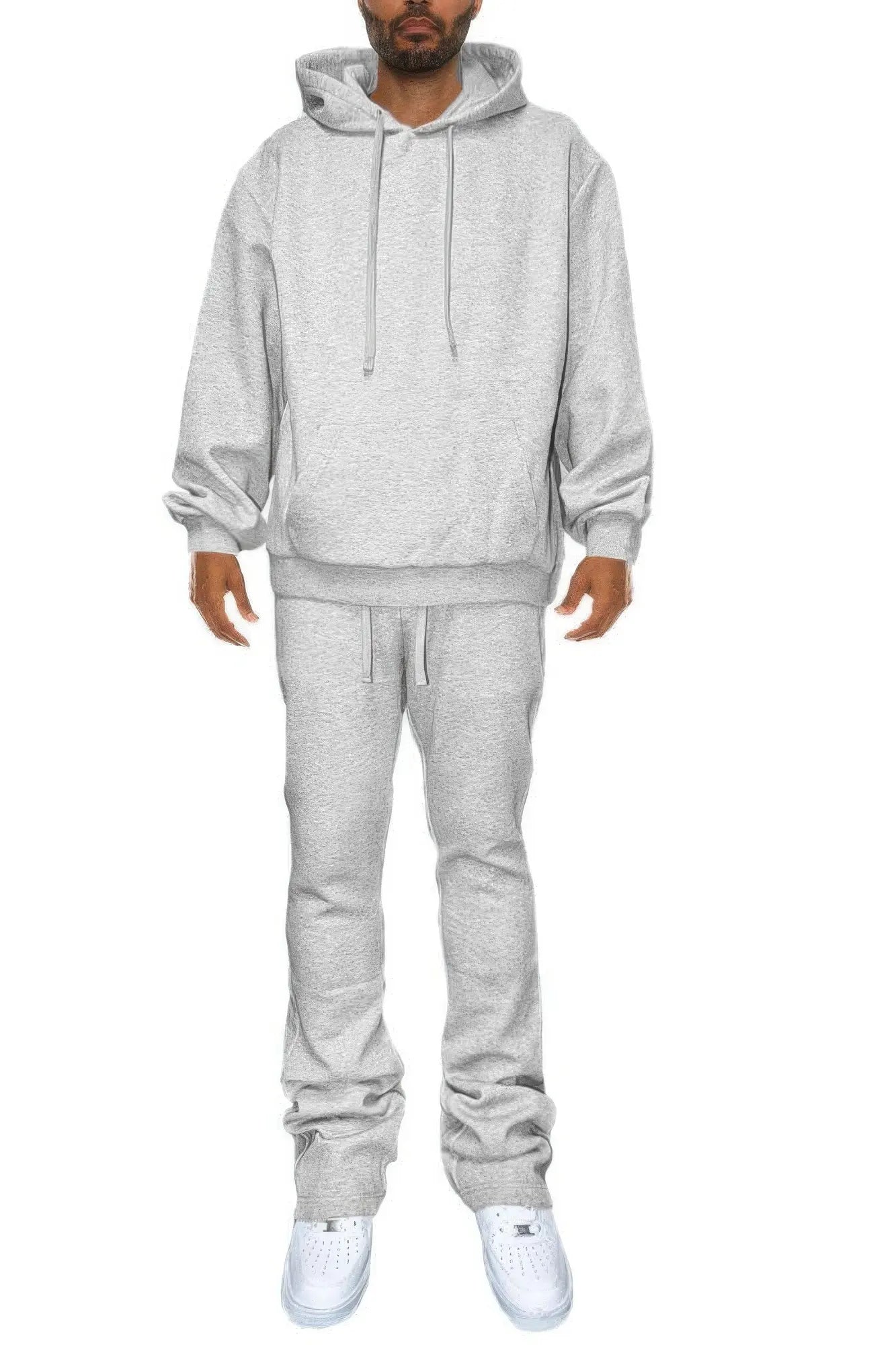 Person wearing a gray hoodie and pants set on a white background