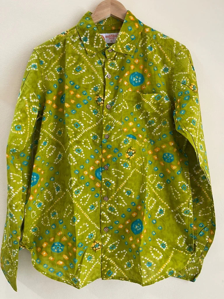 Green patterned shirt on a hanger against a white background