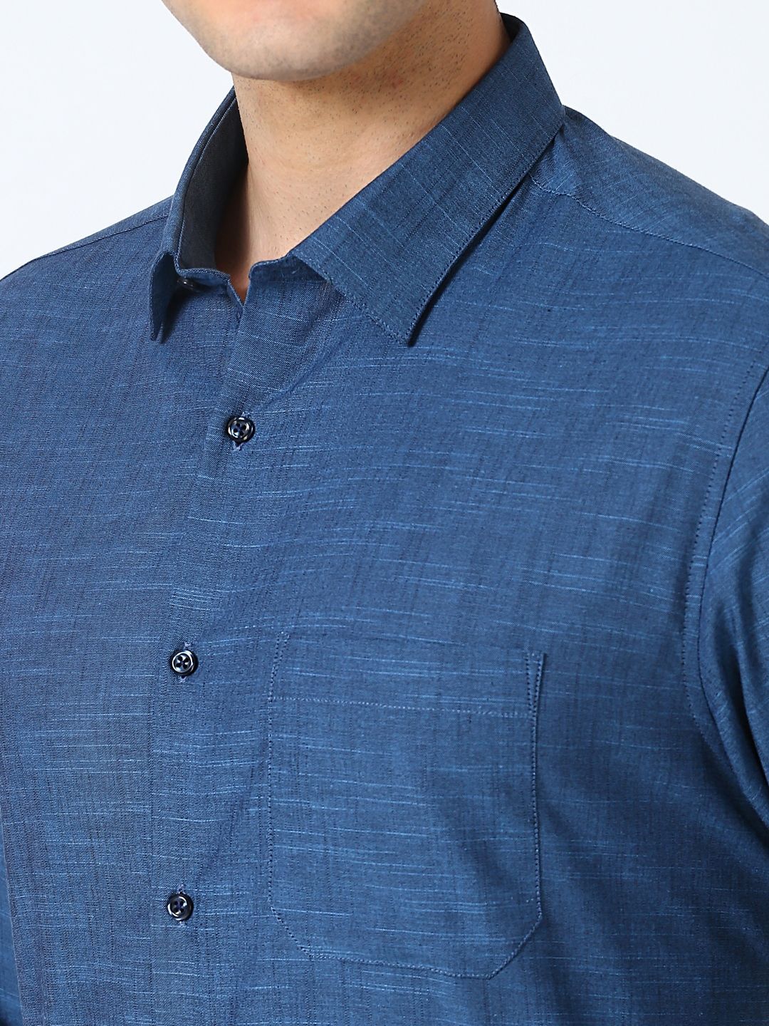 Close-up of a blue shirt with collar and buttons on a white background