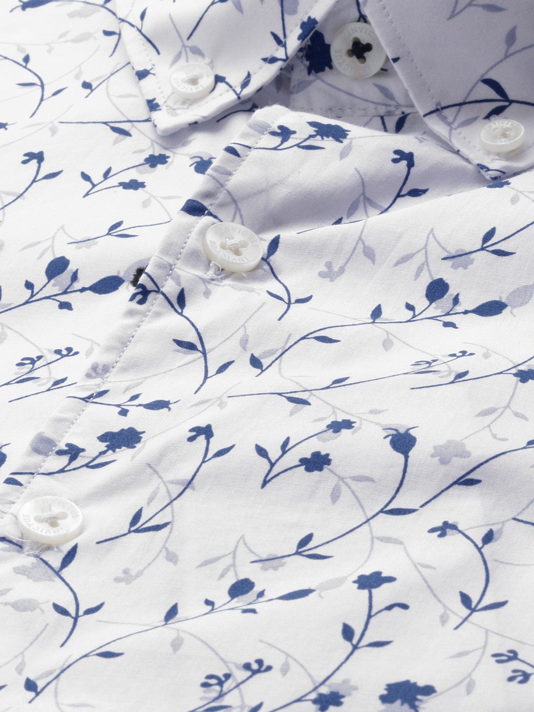 White shirt with blue floral pattern on a white background