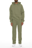 Person wearing a green tracksuit on a white background