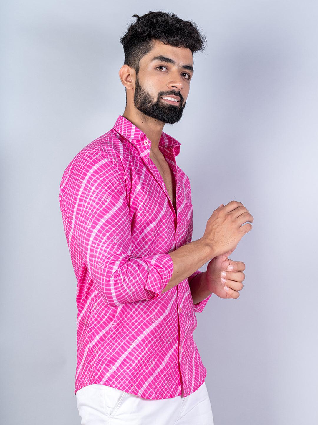 Man wearing a bright pink checkered shirt against a plain background