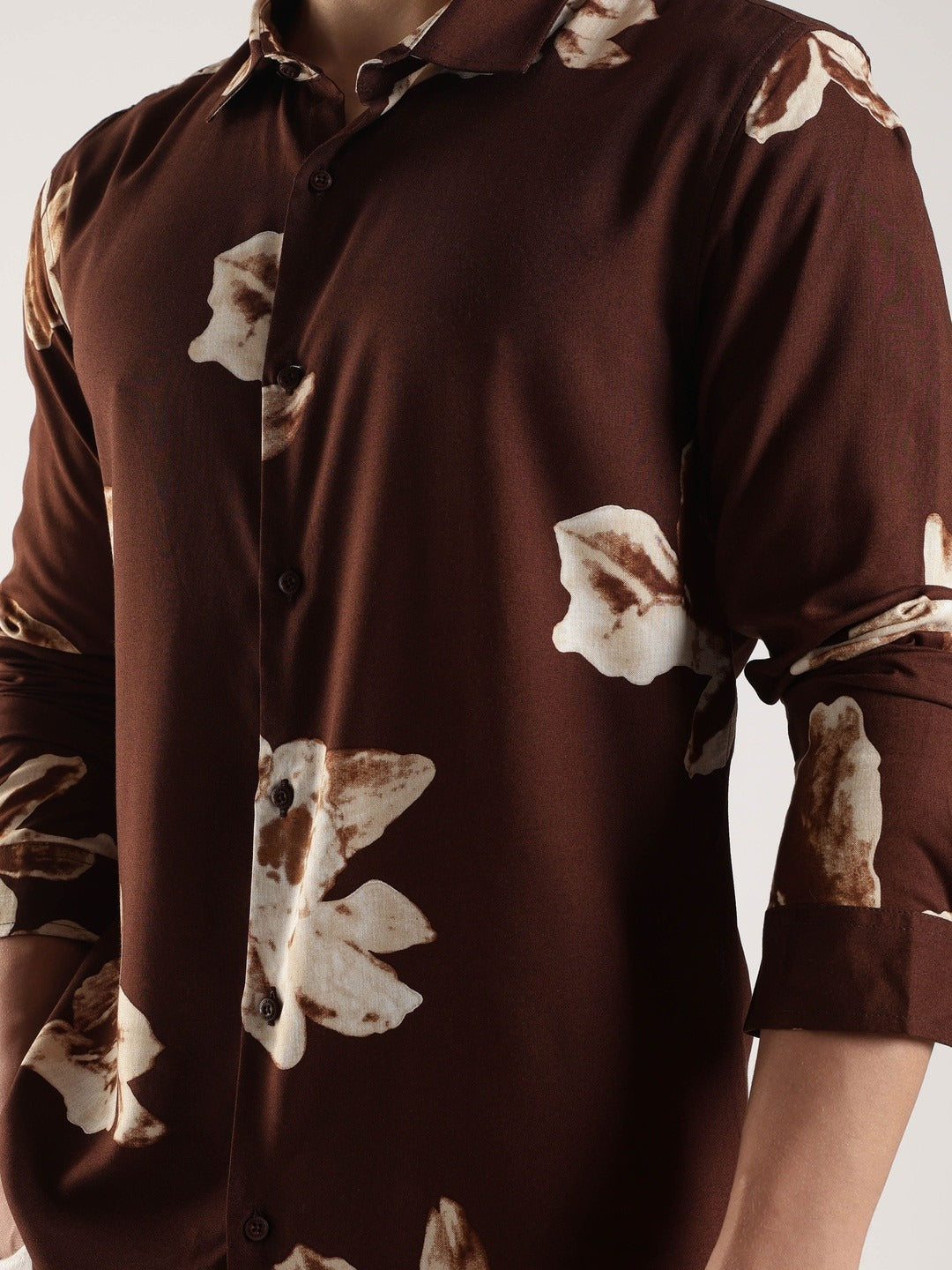 Brown shirt with floral pattern on a plain background