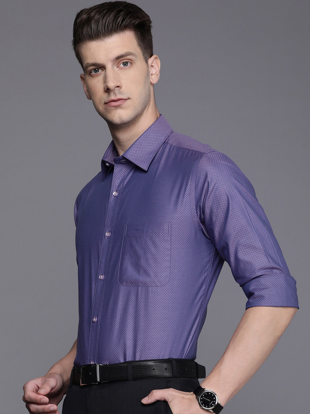 Man wearing a purple dress shirt against a gray background