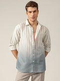 Man wearing a striped shirt with a gradient effect on a plain background