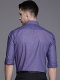 Man wearing a purple shirt with a gray background