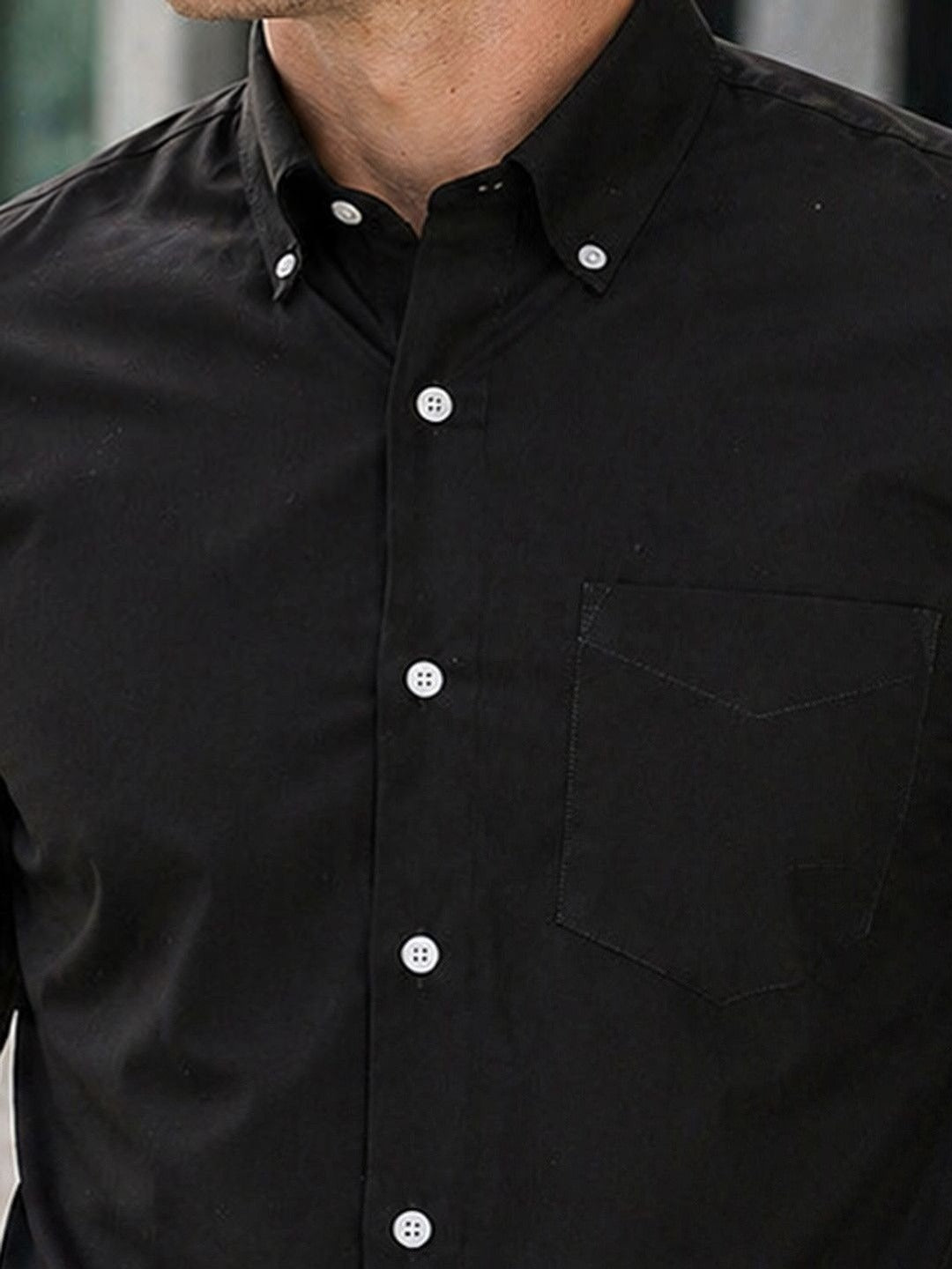 Close-up of a black button-up shirt with a pocket
