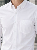 Close-up of a white button-up shirt with a pocket.