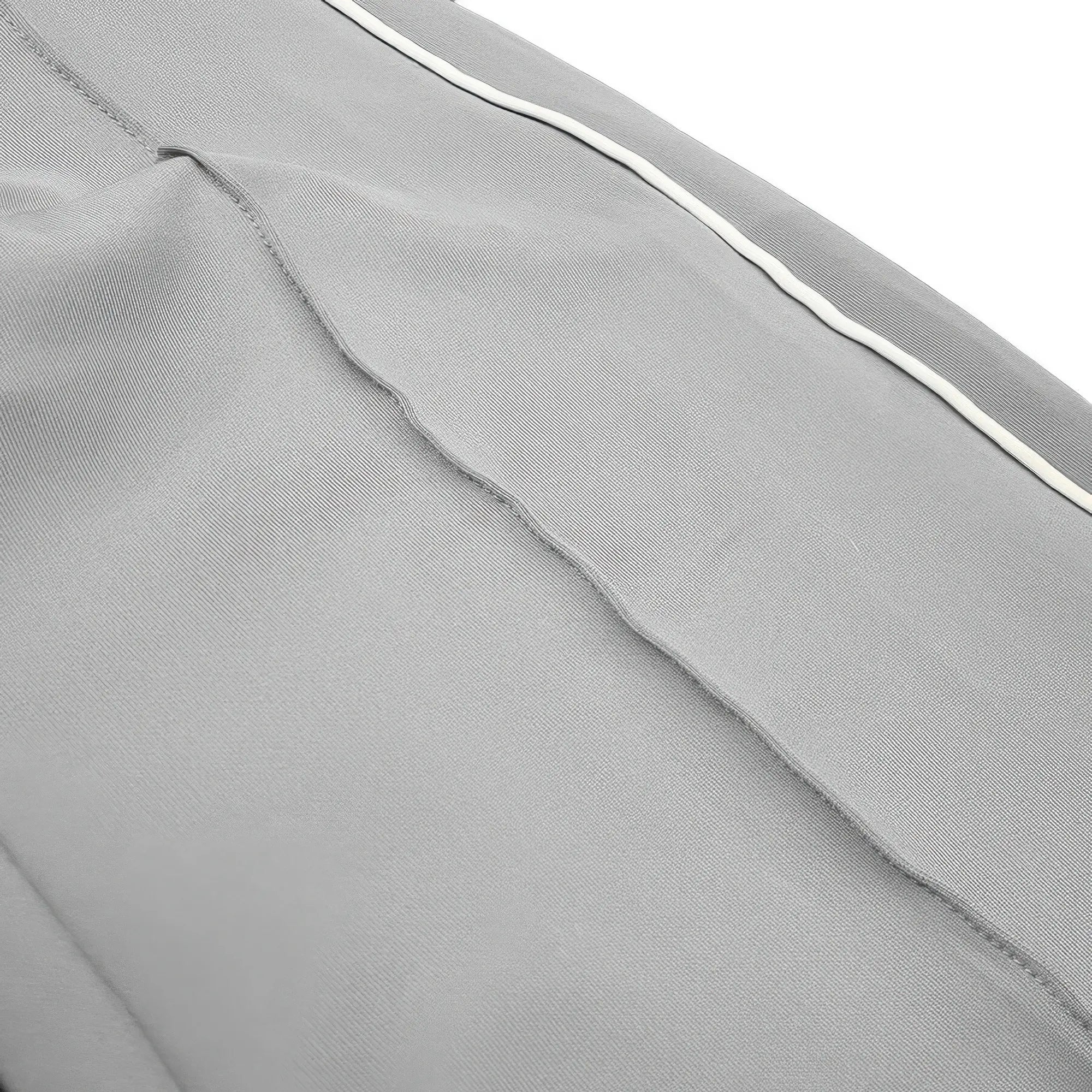 Close-up of gray fabric with a white line on a white background
