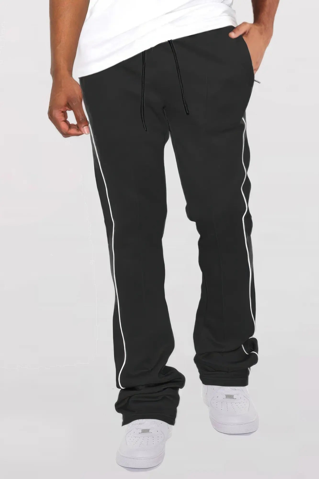 Black jogger pants with white stripes on a white background