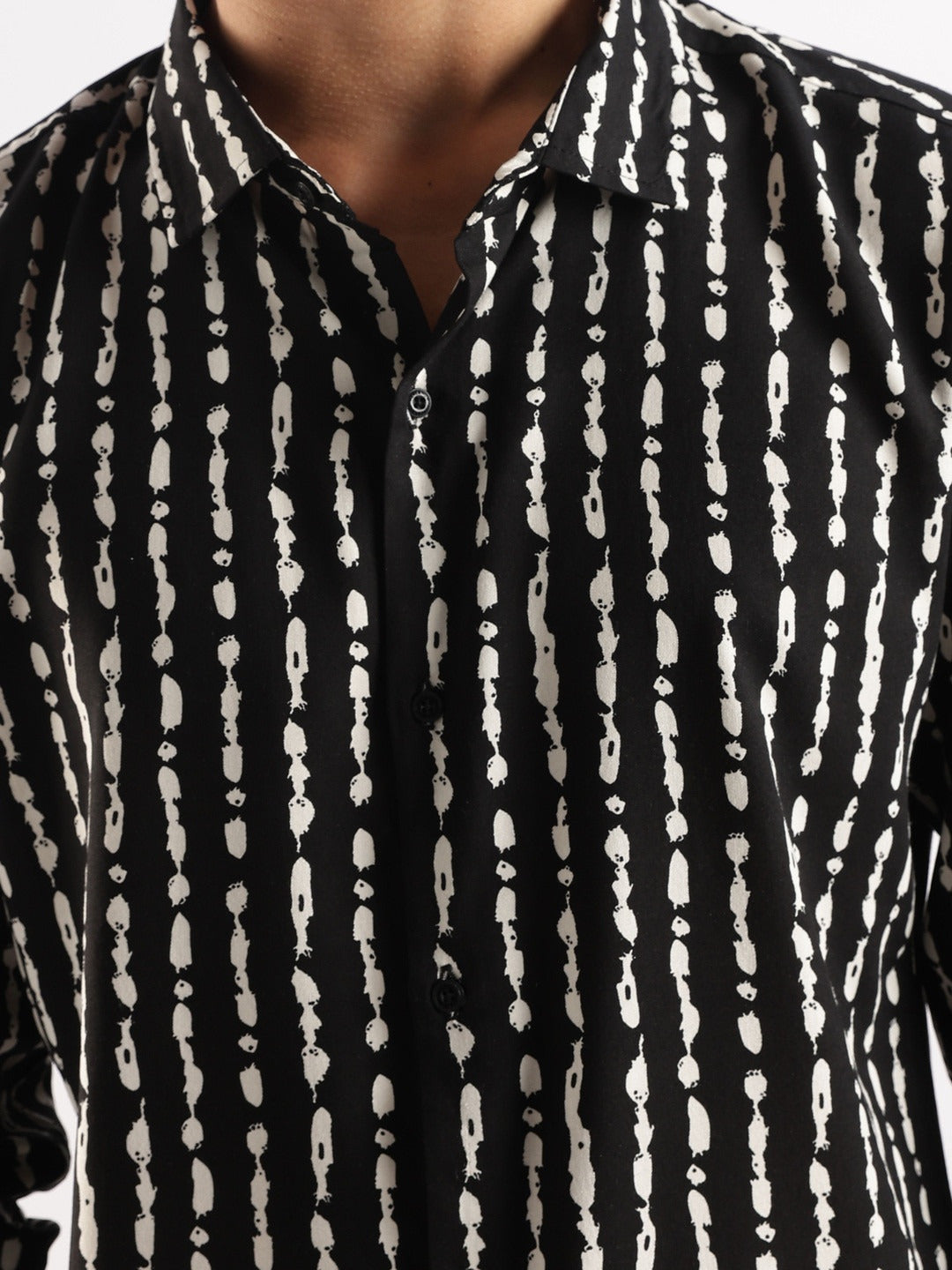Black shirt with white abstract pattern worn by a person