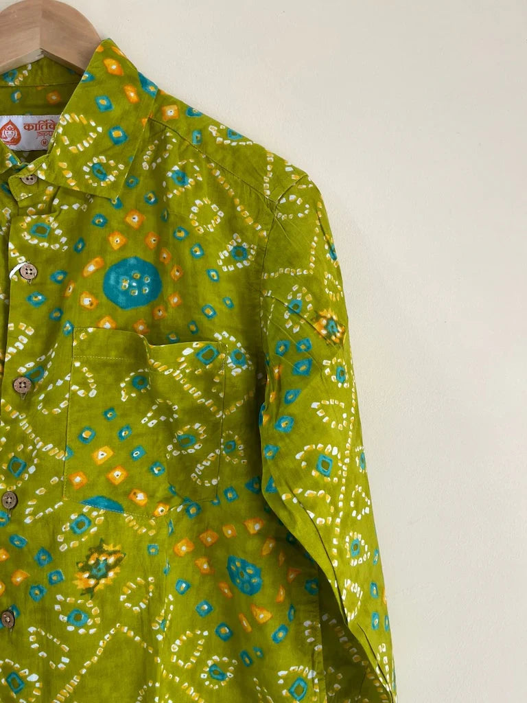 Green patterned shirt on a hanger against a white background