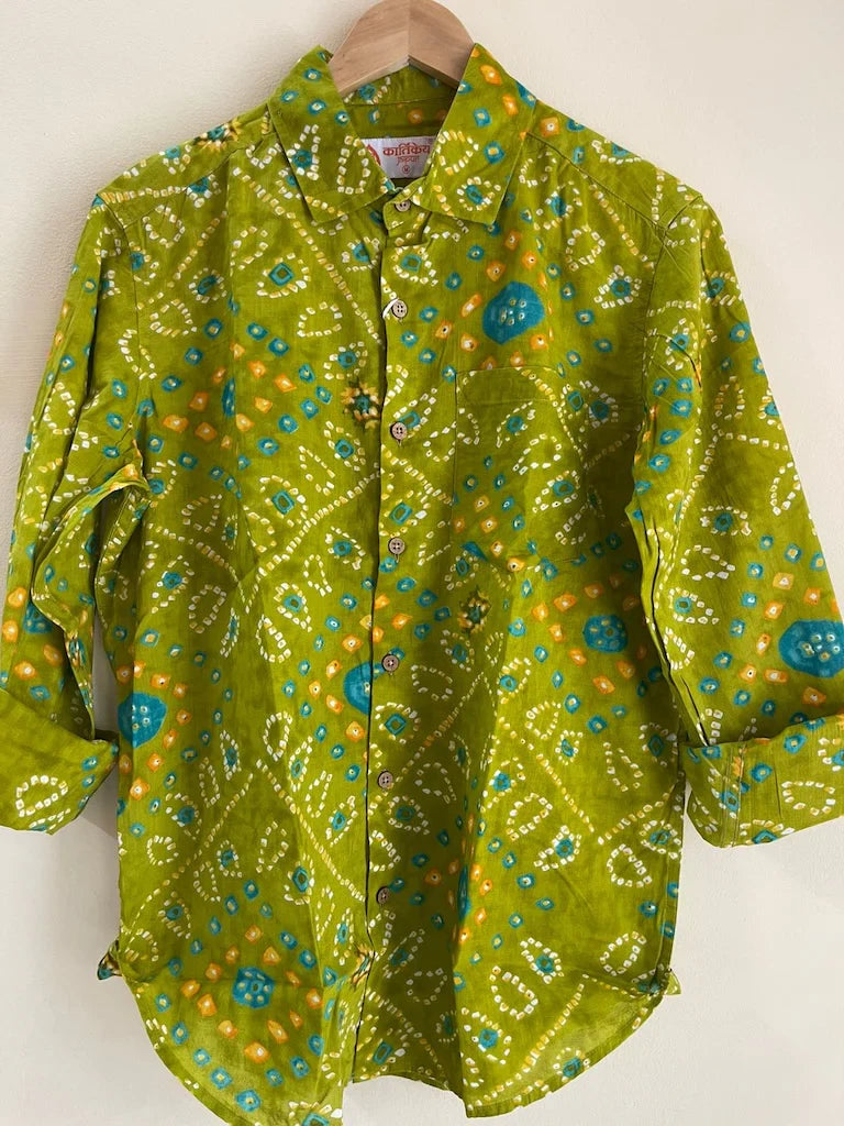 Green patterned shirt on a hanger against a white background