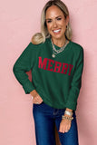 Woman wearing a green sweatshirt with 'MERRY' in red text against a pink background