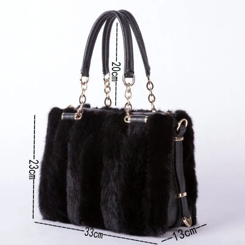 Black fur handbag with gold accents and measurements on a white background