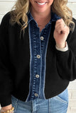 A woman wearing a black ribbed cardigan over a blue denim button-front shirt, paired with light blue jeans, shown from the mouth down against a white brick wall.