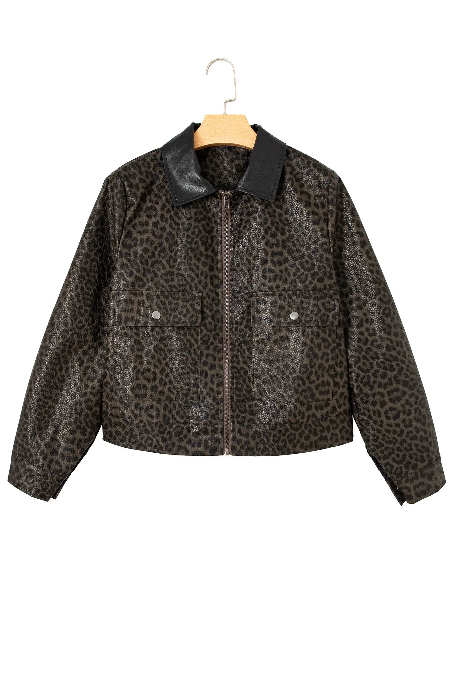 A cropped faux-leather jacket with a brown and black leopard print pattern, featuring a solid black collar and front zipper, hanging on a wooden hanger against a white background.