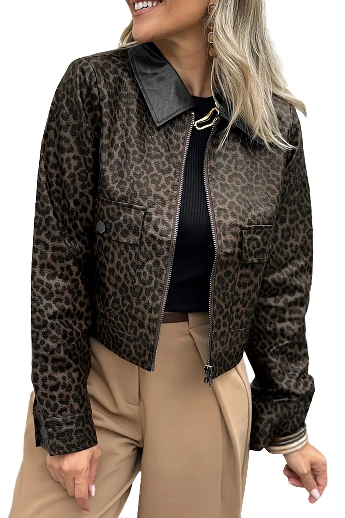 A woman wearing a cropped leopard-print jacket with a black collar, black top, and beige pants, shown against a plain white background.