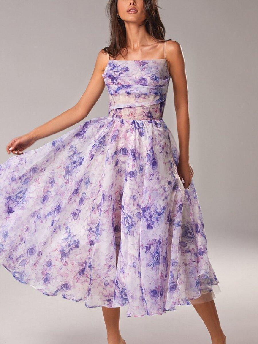 Woman wearing a floral dress with a gray background