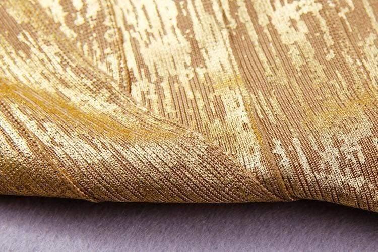 Close-up of textured gold fabric on a gray background