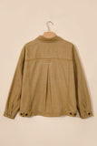 Tan denim jacket back view with pleats and button details, hanging on a wooden hanger against beige background.